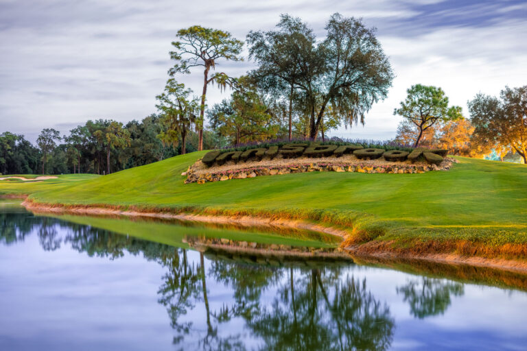 Innisbrook Resort in Palm Harbor Florida 1 The entrance landscaping at the Innisbrook Resort in Palm Harbor, Florida, features the resort’s name sculpted in trimmed hedges along a manicured hill. Reflected in a nearby pond, the display welcomes guests to the golf and spa property known for its championship courses and natural setting. Tall pines and live oaks frame the scene, emphasizing the resort’s park-like character.