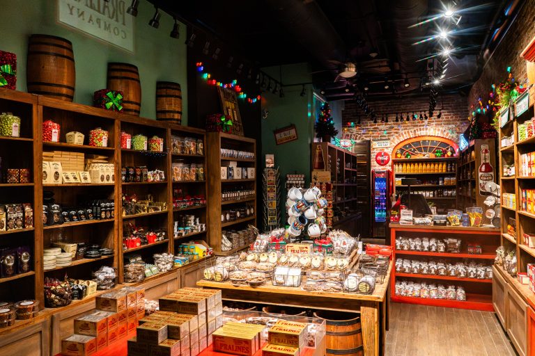 Praline Company Shop Interior, New Orleans 1 Interior of a New Orleans candy shop displaying packaged pralines and confections on wooden shelves and displays.