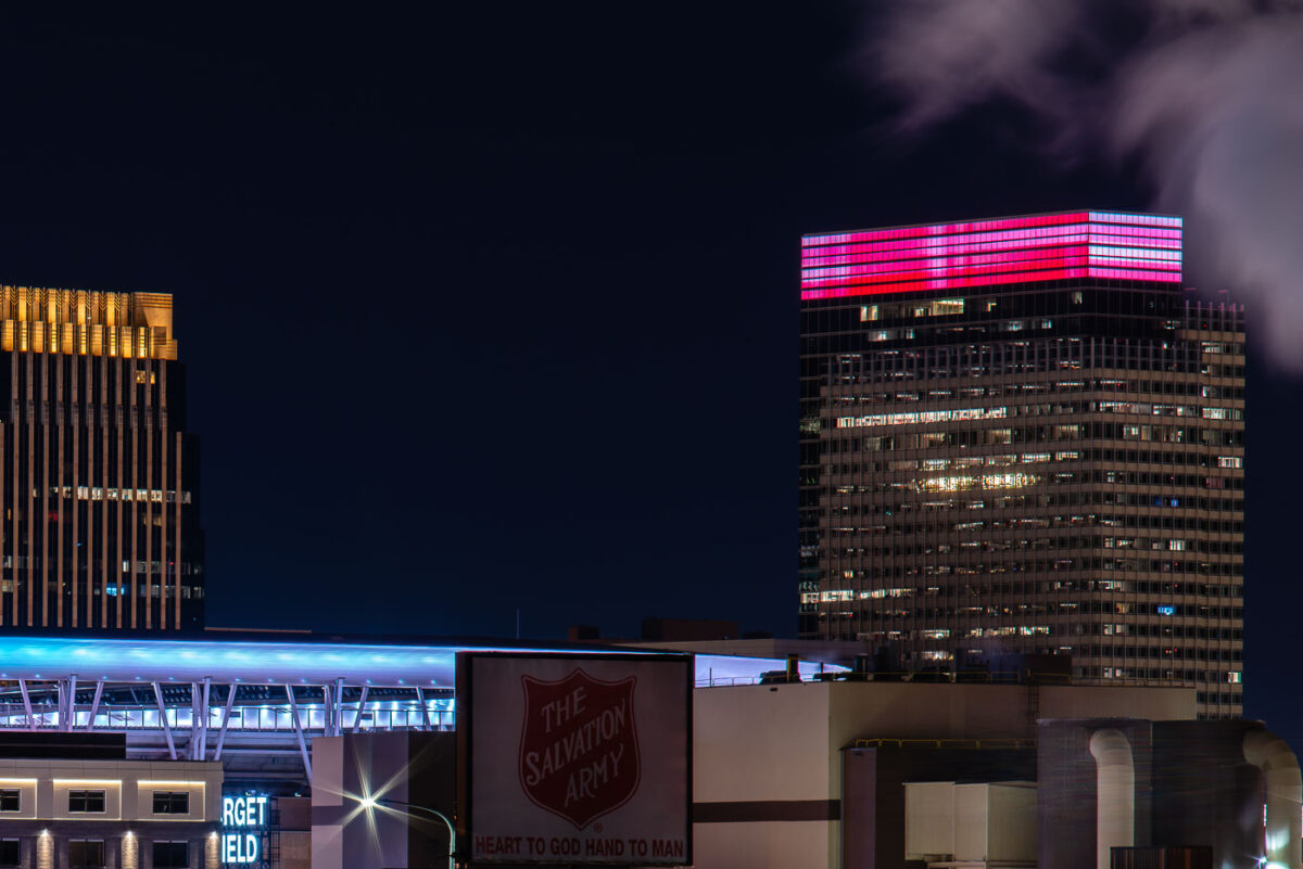 The Salvation Army sign with Target Field and Target Plaza South, Target World Headquarters, in the North Loop in Minneapolis.