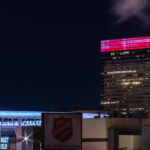 The Salvation Army sign with Target Field and Target Plaza South, Target World Headquarters, in the North Loop in Minneapolis.