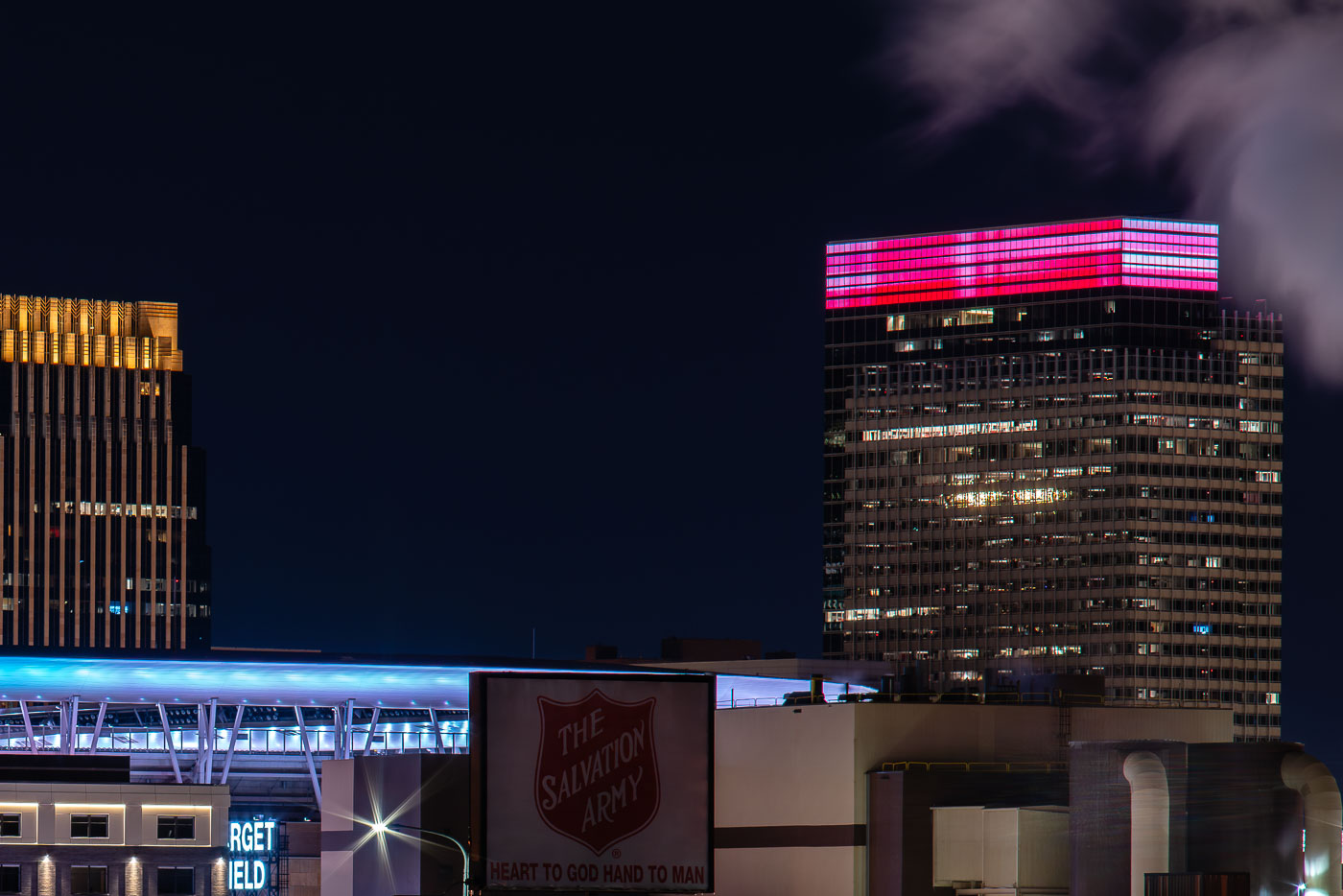 The Salvation Army sign with Target Field and Target Plaza South, Target World Headquarters, in the North Loop in Minneapolis.