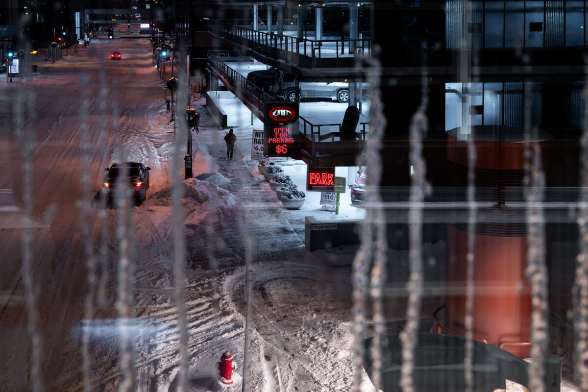 Icy downtown Minneapolis street beside skyway parking ramp