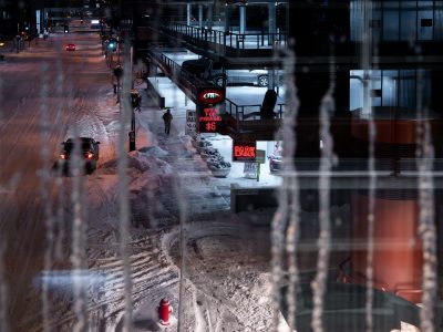 Icy downtown Minneapolis street beside skyway parking ramp