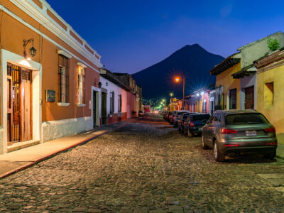 Antigua Guatemala street at dusk with Agua Volcano
