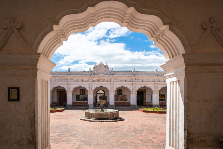 Palacio de los Capitanes Generales, Antigua Guatemala 1 Ornate arched stone entrance frames a colonial courtyard with central fountain and arcaded buildings.
