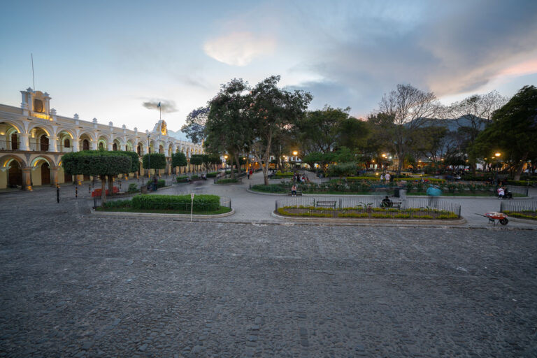 Parque Central, Antigua Guatemala at Dusk 1 Parque Central in Antigua Guatemala, a UNESCO World Heritage site, is the city's main public square. Established in the 16th century, it served as the heart of colonial life and administration. The square is flanked by historic buildings, including the Palace of the Captains General, which now houses government offices and a museum. Today, Parque Central remains a vibrant gathering place for locals and tourists, featuring gardens, fountains, and pathways, all set against the backdrop of Antigua's well-preserved Spanish Baroque architecture and cobblestone streets.