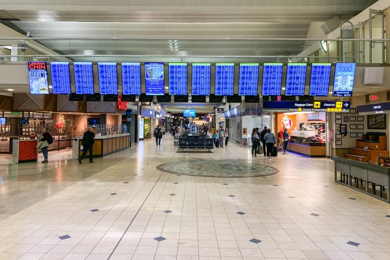Terminal 1 Concourse, Minneapolis-Saint Paul International Airport 1 Airport terminal concourse with departure boards, retail shops, and scattered passengers at Minneapolis-St. Paul International