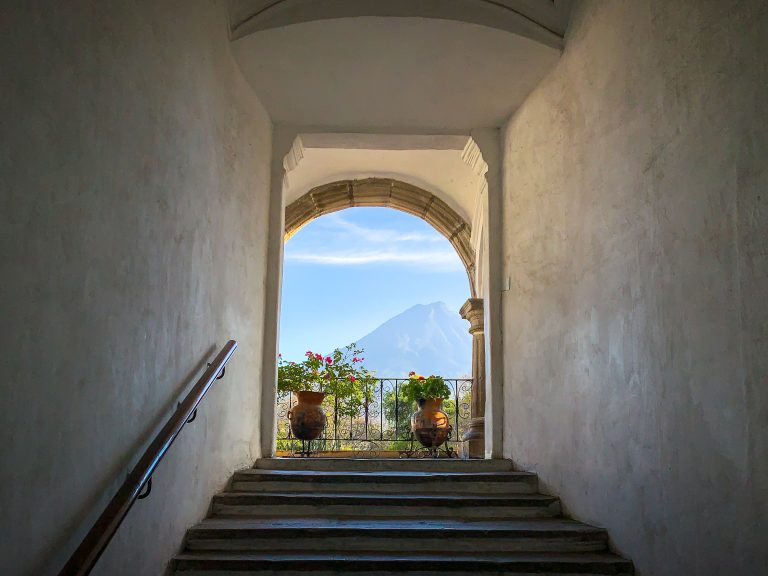 Volcán de Agua View from Colonial Archway, Antigua Guatemala 4 Stone archway framing a terrace with potted flowers overlooking a distant volcano.