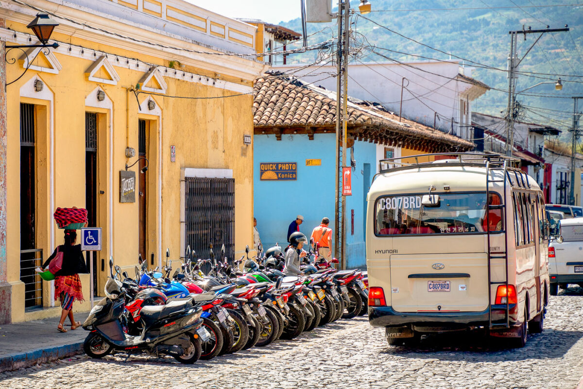 Woman carrying bread in Antigua, Guatemala and a bunch of motor bikes.