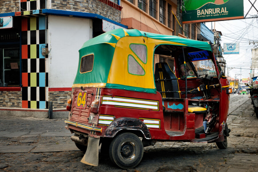 San Pedro, Guatemala: Colorful Tuk Tuk on Cobblestone Street