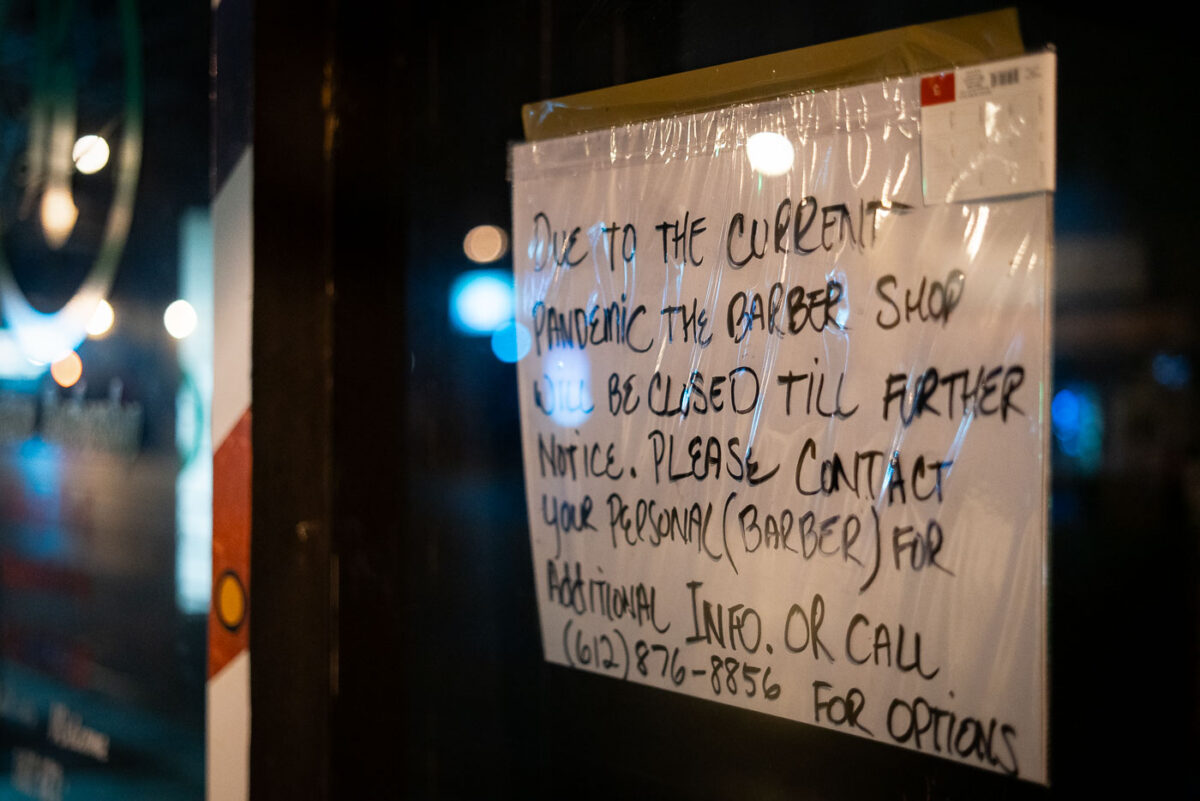 A pandemic closure sign on a barber shop in Minneapolis