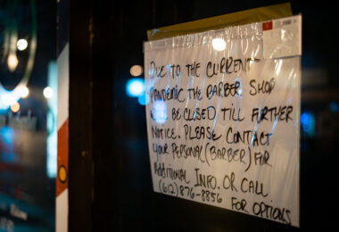 A pandemic closure sign on a barber shop in Minneapolis