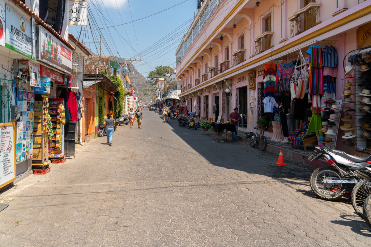 Tourists walk down a street in Panajachel, Guatemala.