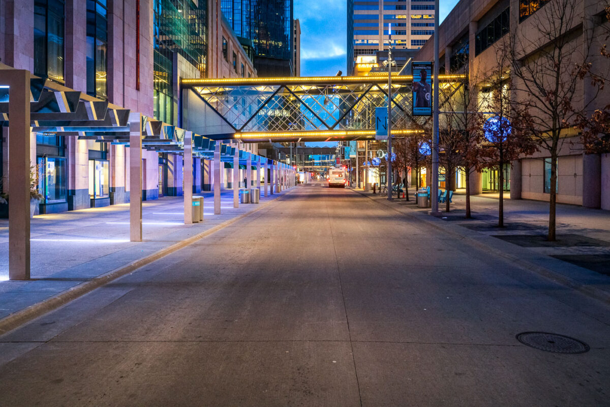 Nicollet Mall in Downtown Minneapolis during the coronavirus (COVID-19) outbreak. Normally busy with pedestrians and buses, only one Metro Transit Bus and bicycle is found in view.