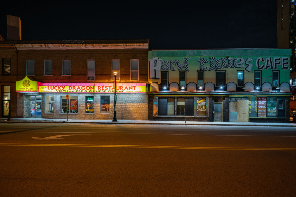 Lucky Dragon Restaurant and Hard Times Cafe on Riverside Avenue in Minneapolis at night, with boarded windows.