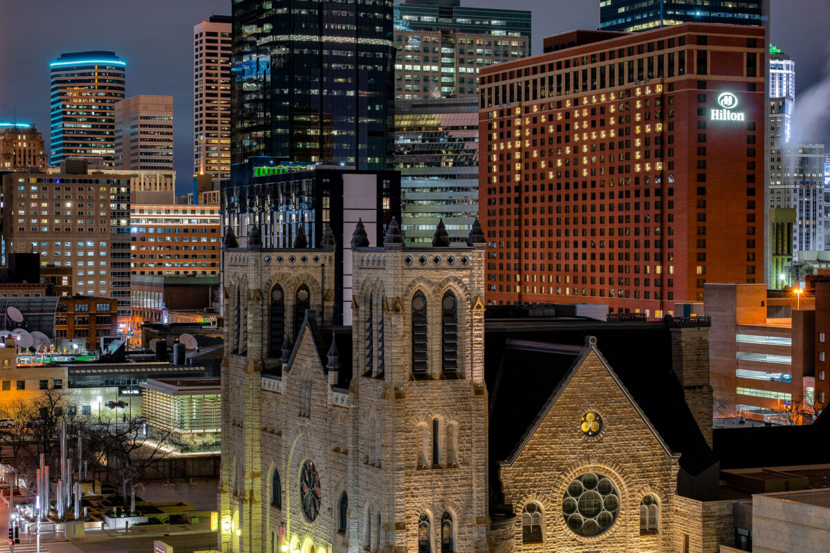 Hilton Minneapolis in downtown Minneapolis with “HOPE” and a heart lit in hotel windows during COVID-19.