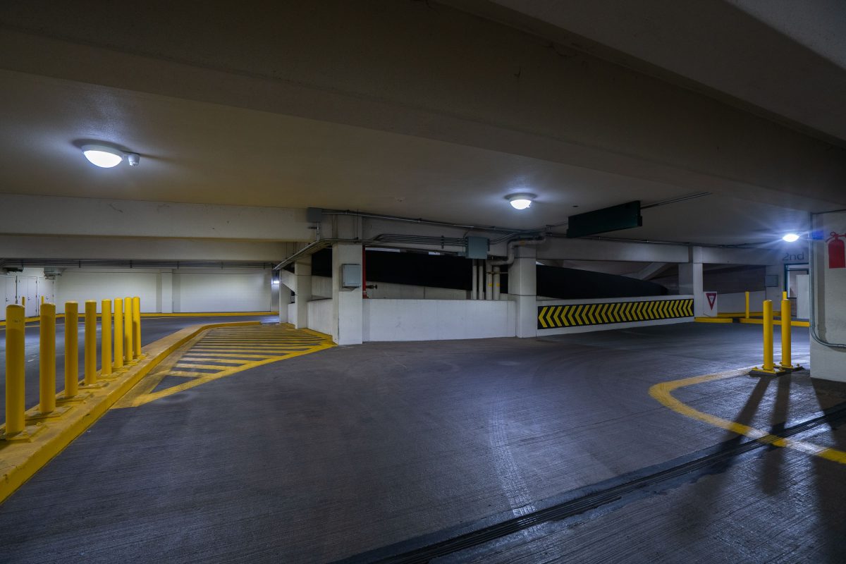 Empty parking ramp with yellow safety barriers and overhead lighting in downtown Minneapolis.