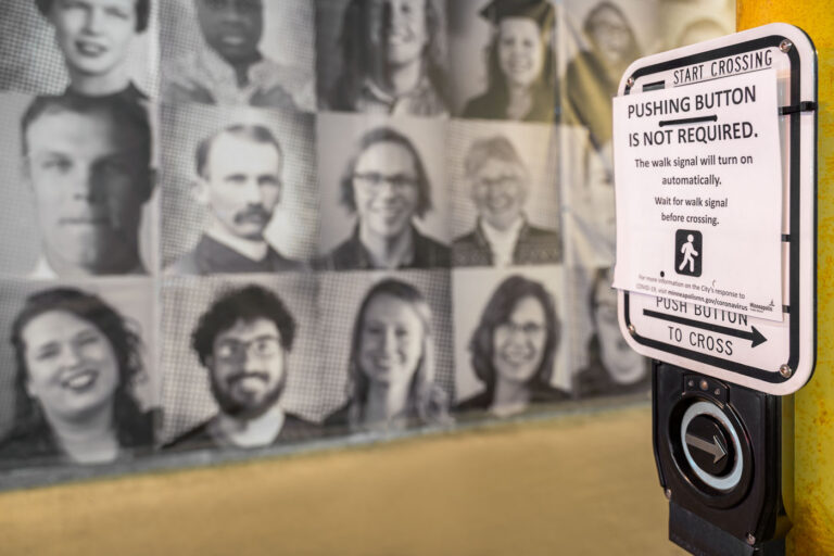Minneapolis Crosswalk button 4 A crosswalk button in Minneapolis after the city disabled 450 walk buttons in late April 2020. Sign reads "Pushing button is not required. The walk signal will turn on automatically. Wait for walk signal before crossing."