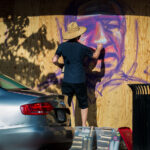 A street artist painting boards on Hennepin Ave on May 31, 2020 after days of protests following the death of George Floyd on May 25th, 2020.