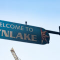 A burned "Welcome to Lynlake" sign on Lake Street and Lyndale Avenue on May 30, 2020. The sign was burned from dumpsters on fire below it after the murder of George Floyd.