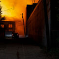 A car drives down an alley filled with smoke from fires on the 2nd day of protests in Minneapolis following the death of George Floyd.