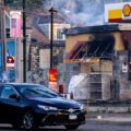 A car drives by a Shell gas station on Lake Street in Minneapolis on the morning of May 30, 2020 after nights of fires in Minneapolis.