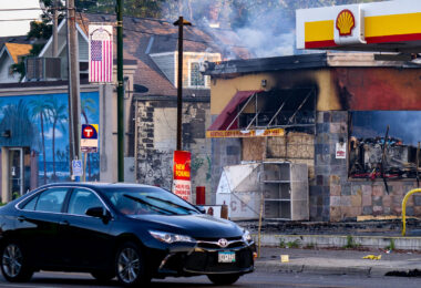A car drives by a Shell gas station on Lake Street in Minneapolis on the morning of May 30, 2020 after nights of fires in Minneapolis.