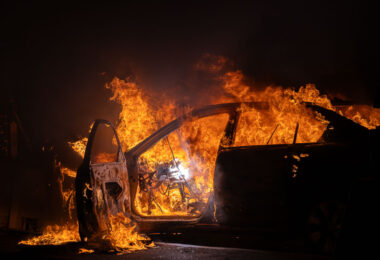 A car burns at Wells Fargo bank on E 31st St, across from the Minneapolis Police 5th Precinct. Protesters had gathered following a march through South Minneapolis on the 4th day of protests in Minneapolis following the death of George Floyd.