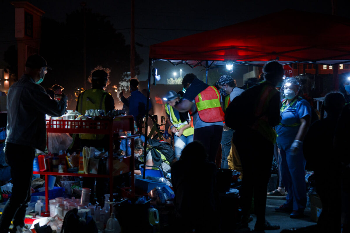 Community medics tend to those injured at protests outside the Minneapolis Police 3rd Precinct.