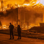 A 6-story new housing development on fire near the Minneapolis Police 3rd Precinct during the 2nd day of protests in Minneapolis following the death of George Floyd.