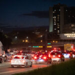 Vehicles follow protesters who had been marching down I-94. Curfew went into place at 8pm.