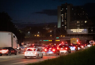Vehicles follow protesters who had been marching down I-94. Curfew went into place at 8pm.