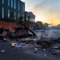 The sun rising on May 30, 2020 in Minneapolis over Lake Street. The street littered with debris from fires after the 4th day of protests in Minneapolis following the death of George Floyd.