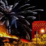 Fireworks explode above Minnehaha Liquor on Lake Street during the 3rd day of protests in Minneapolis following the death of George Floyd.