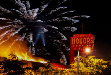 Fireworks explode above Minnehaha Liquor on Lake Street during the 3rd day of protests in Minneapolis following the death of George Floyd.
