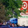 Protesters gather below a Target sign across from the Minneapolis Police third precinct.