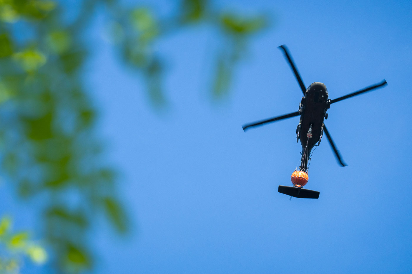 Helicopter with water to drop on burning fires