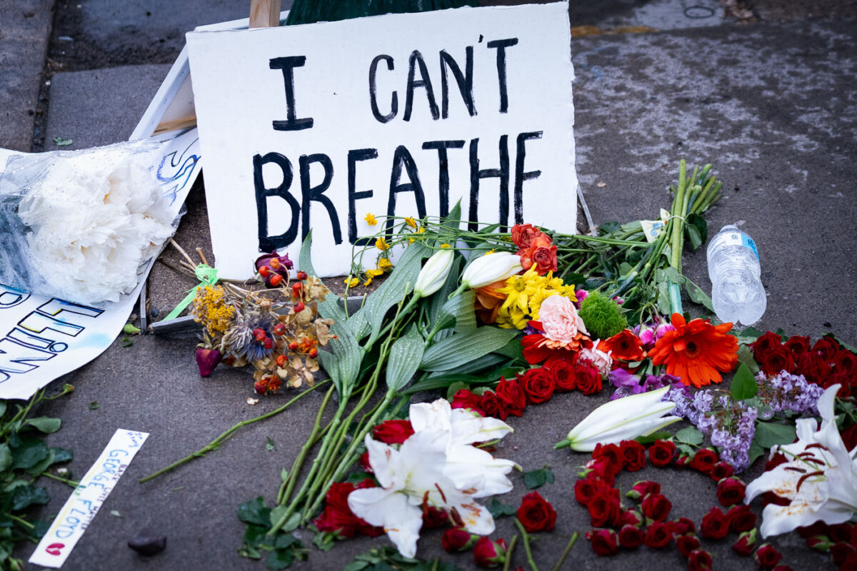 A sign reading “I can’t breath” and flowers left behind where George Floyd was killed the night before.