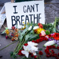 A sign reading “I can’t breath” and flowers left behind where George Floyd was killed the night before.