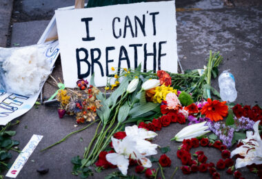 A sign reading “I can’t breath” and flowers left behind where George Floyd was killed the night before.