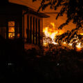 A fire burning across the street from a home on E 29th St on the 2nd day of protests in Minneapolis following the death of George Floyd.