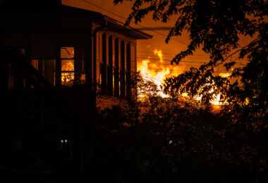 A fire burning across the street from a home on E 29th St on the 2nd day of protests in Minneapolis following the death of George Floyd.