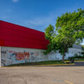 A man lies on the grass outside of the Target Store on East Lake Street in South Minneapolis. Graffiti covered the store that sits across from the Minneapolis Police 3rd Precinct.