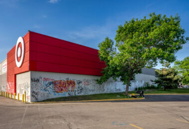 A man lies on the grass outside of the Target Store on East Lake Street in South Minneapolis. Graffiti covered the store that sits across from the Minneapolis Police 3rd Precinct.