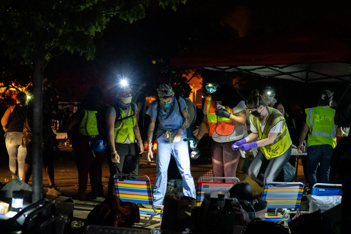 Community medics tend to those injured at protests outside the Minneapolis Police 3rd Precinct on May 28, 2020.