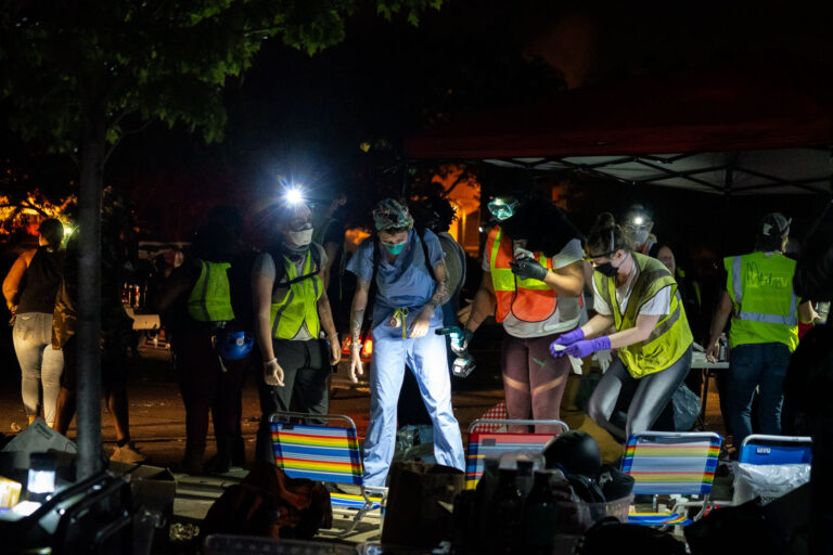 Protest medics outside a burning 3rd Precinct 1 Community medics tend to those injured at protests outside the Minneapolis Police 3rd Precinct on May 28, 2020.