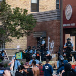 Protesters and Minneapolis police outside the third precinct on May 27th, 2020, the second day of protests following the death of George Floyd.