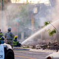 Minnesota National Guard and Minneapolis Police look on as the Minneapolis Fire Department fight fires on Lake Street after another night of protests and riots in Minneapolis after the death of George Floyd.