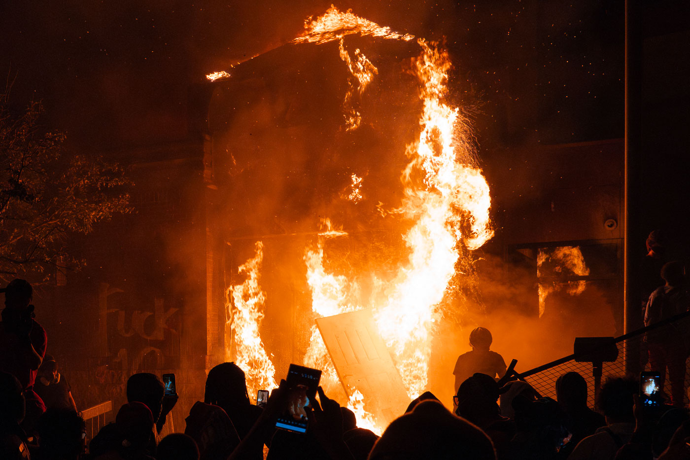 Minneapolis police station on fire with protesters in front