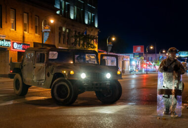 The Minnesota National Guard on Lake Street on May 30, 2020 while Minneapolis Fire Department puts out nearby fires on the 4th day of protests in Minneapolis following the death of George Floyd.